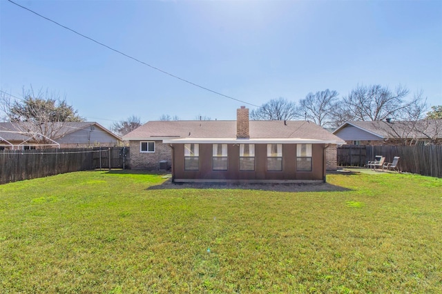 back of property featuring a lawn