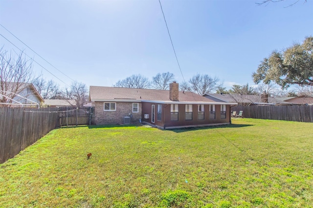back of property featuring a yard and central air condition unit