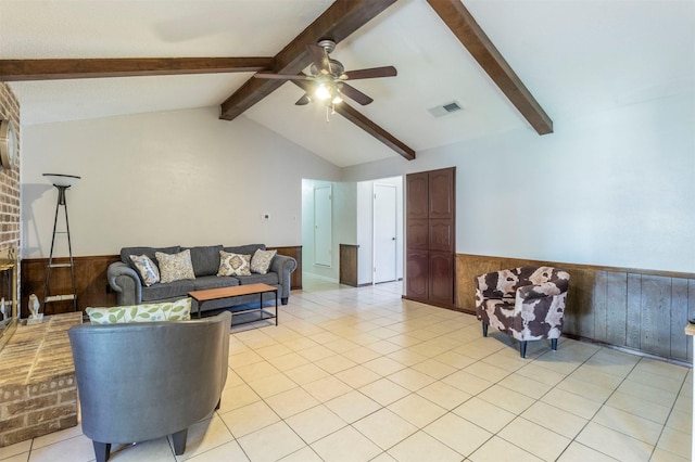 living room with ceiling fan, light tile patterned flooring, vaulted ceiling with beams, and wood walls