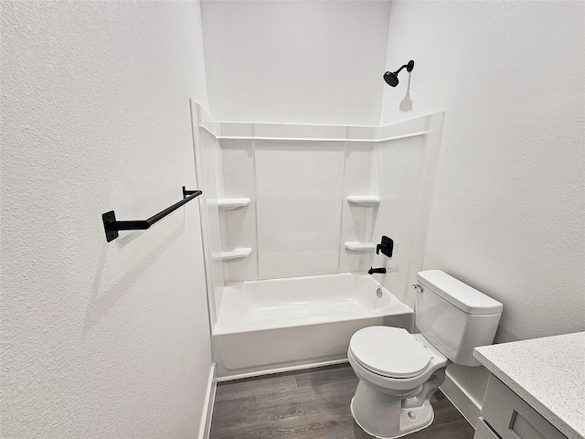 6130 Inca Dr, Mabank, TX 75156 - full bath with toilet, vanity, shower / washtub combination, wood finished floors, and a textured wall