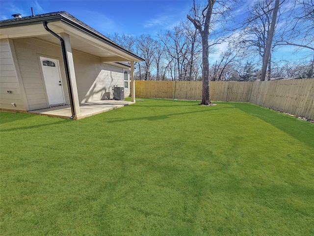 view of yard with central air condition unit and a patio area