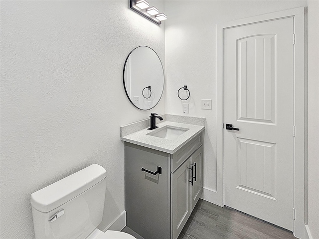 6130 Inca Dr, Mabank, TX 75156 - half bath featuring toilet, wood finished floors, baseboards, and vanity
