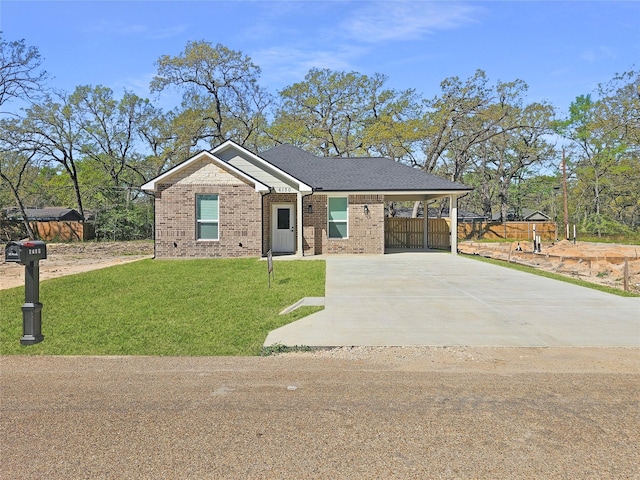 6130 Inca Dr, Mabank, TX 75156 - view of front of house with an attached carport, a front yard, brick siding, and fence