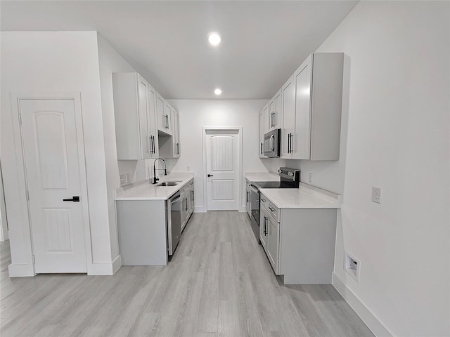 6130 Inca Dr, Mabank, TX 75156 - kitchen featuring light countertops, light wood finished floors, baseboards, stainless steel appliances, and a sink