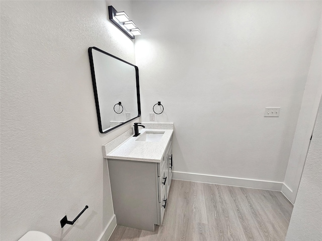 bathroom featuring hardwood / wood-style flooring and vanity