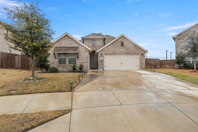 view of property featuring a garage and a front lawn