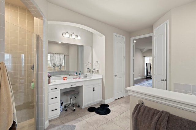 bathroom featuring vanity, tile patterned flooring, plenty of natural light, and a shower with door