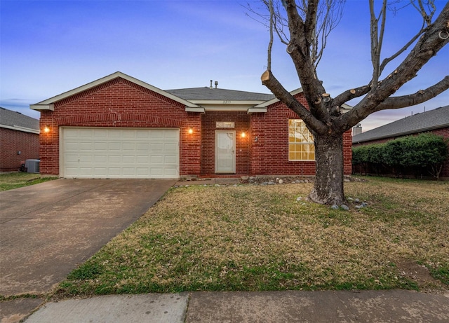 ranch-style home with central air condition unit, a garage, and a yard