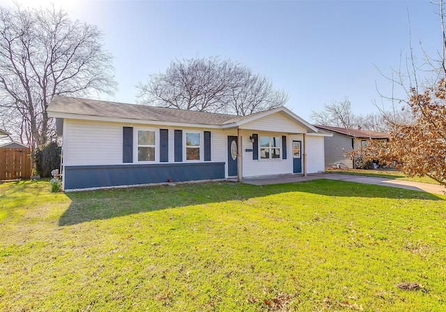 ranch-style home with driveway and a front lawn