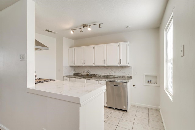 kitchen featuring a peninsula, a sink, white cabinets, light countertops, and stainless steel dishwasher