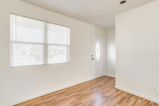 entrance foyer featuring light wood-type flooring and baseboards