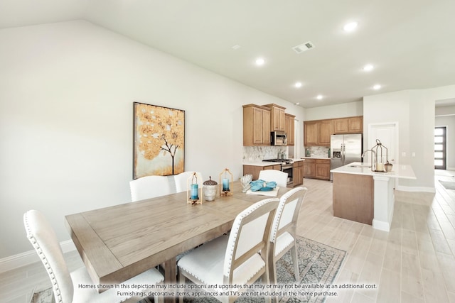 9352 Wildcat Rdg, Godley, TX 76044 - dining area with sink, light hardwood / wood-style floors, and lofted ceiling