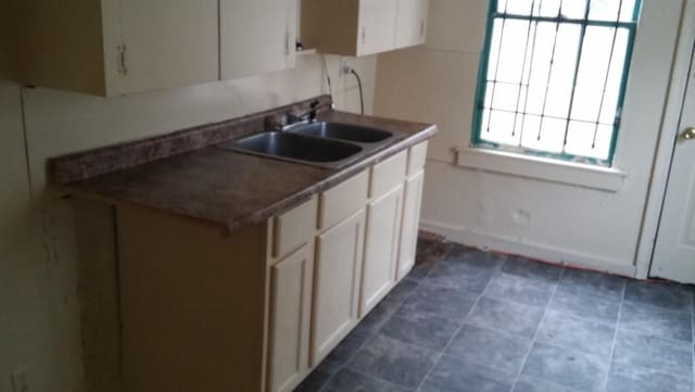 kitchen featuring sink and white cabinets