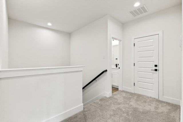 foyer featuring light carpet, baseboards, visible vents, and recessed lighting