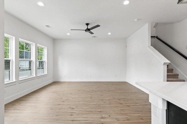 interior space featuring recessed lighting, stairway, light wood-style flooring, ceiling fan, and baseboards