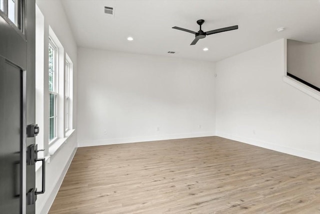 spare room featuring baseboards, recessed lighting, a ceiling fan, and light wood-style floors