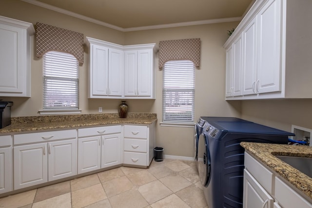 laundry area with ornamental molding, cabinets, washing machine and clothes dryer, and light tile patterned floors