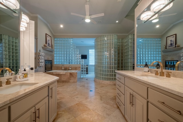 bathroom featuring ceiling fan, vanity, crown molding, and tiled bath