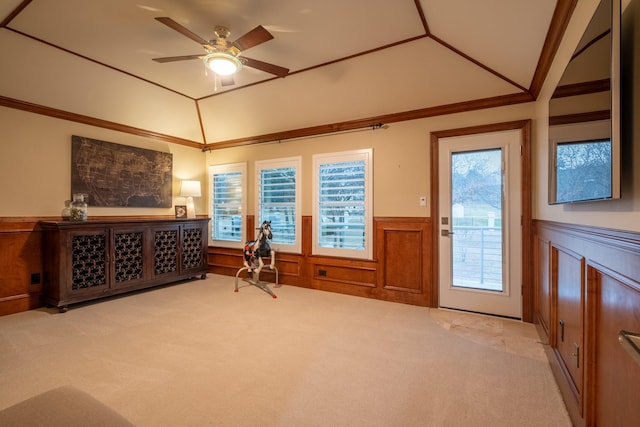 sitting room with ceiling fan, crown molding, light carpet, and lofted ceiling