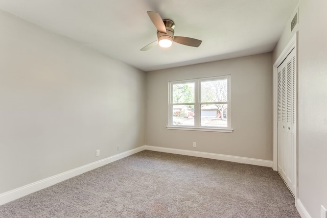 unfurnished bedroom with a closet, ceiling fan, and carpet flooring