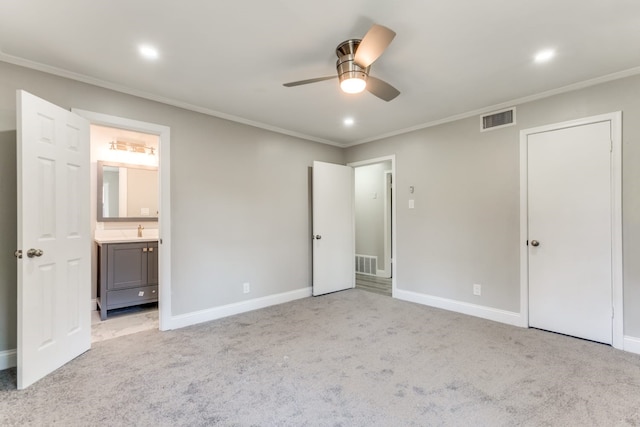 unfurnished bedroom with ornamental molding, sink, light carpet, and connected bathroom