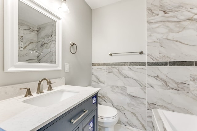 bathroom with tile walls, toilet, and vanity