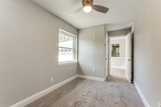 unfurnished bedroom with ceiling fan and light colored carpet