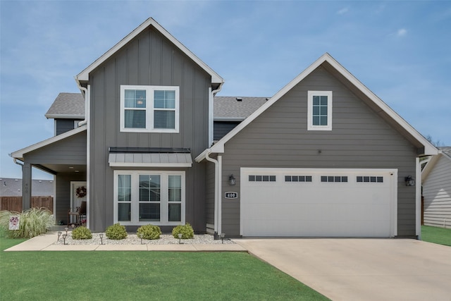 view of front of home featuring an attached garage, a shingled roof, concrete driveway, a front lawn, and board and batten siding