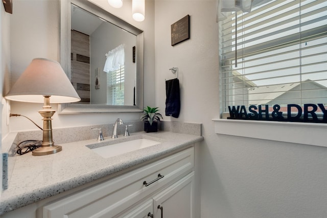 bathroom with plenty of natural light and vanity