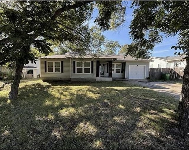 single story home featuring a garage and a front lawn