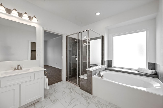 bathroom featuring vanity and shower with separate bathtub