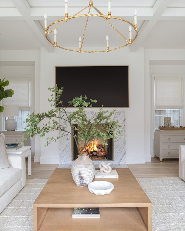 living room with light hardwood / wood-style flooring and a notable chandelier