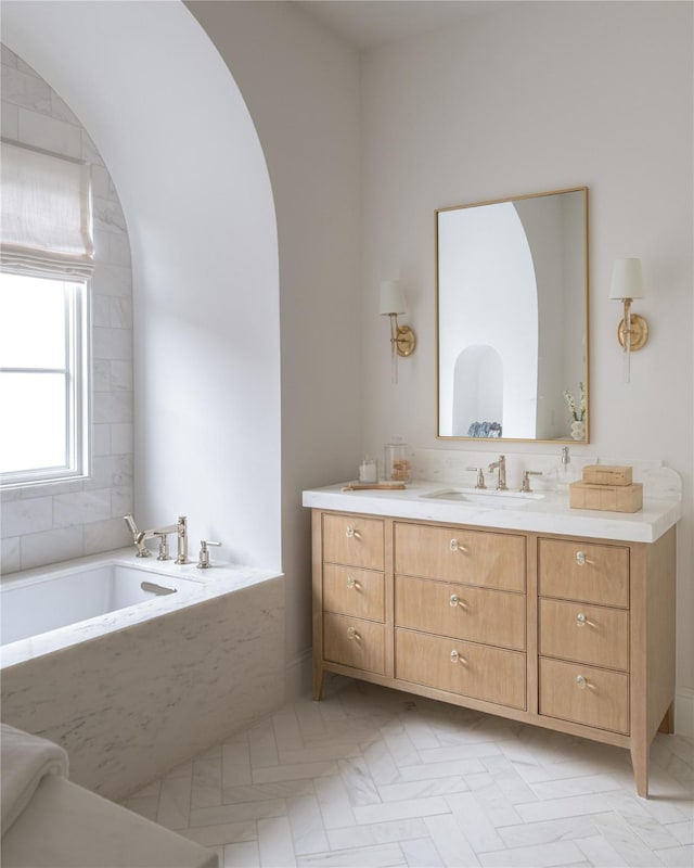 bathroom featuring vanity and a washtub