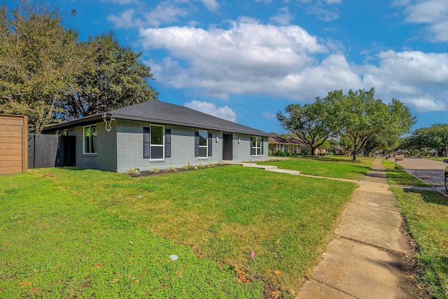 ranch-style home with fence, a front lawn, and brick siding