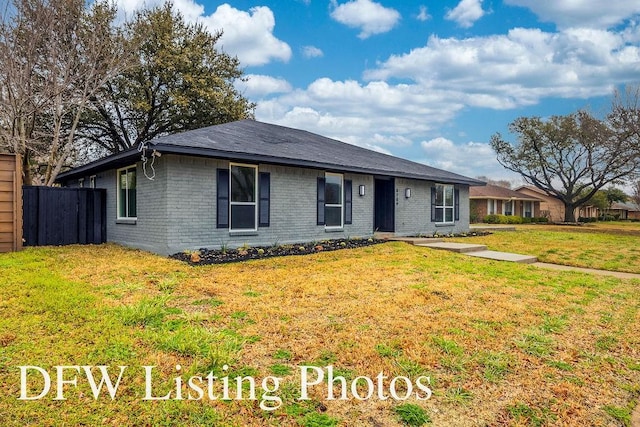 ranch-style house with brick siding, a front yard, and fence