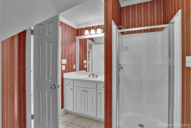 bathroom with tile patterned flooring, crown molding, vanity, and a shower