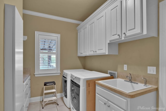 clothes washing area with washer and dryer, sink, light tile patterned flooring, cabinets, and crown molding