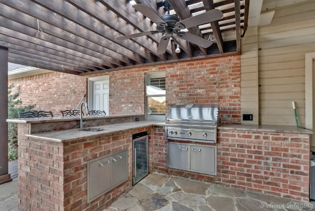 view of patio featuring exterior kitchen, area for grilling, sink, ceiling fan, and beverage cooler