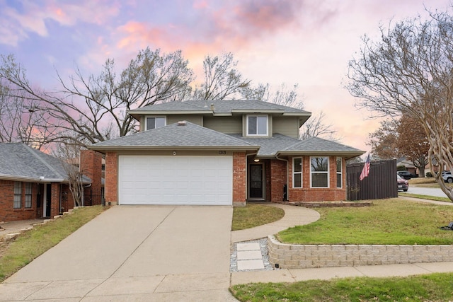 view of front of home with a yard and a garage