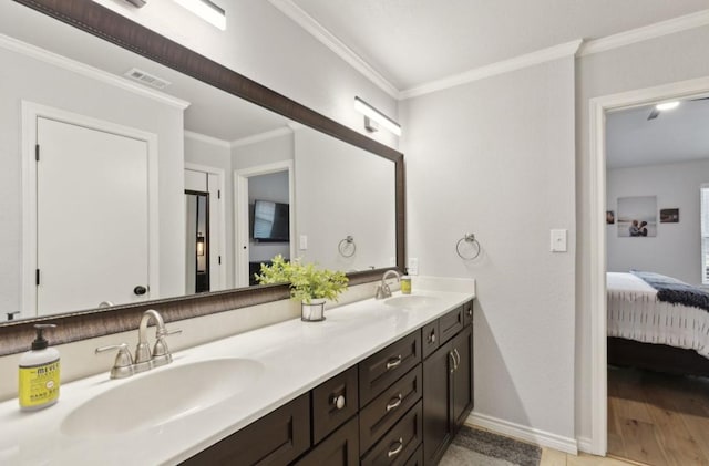 bathroom with ornamental molding and vanity