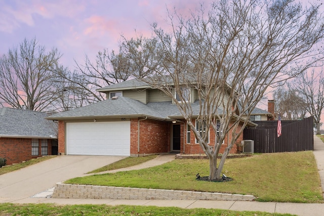 front facade with a garage, a yard, and cooling unit