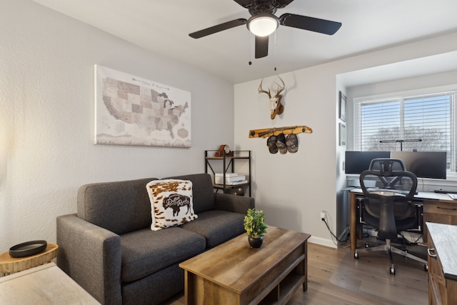 living room featuring hardwood / wood-style flooring and ceiling fan