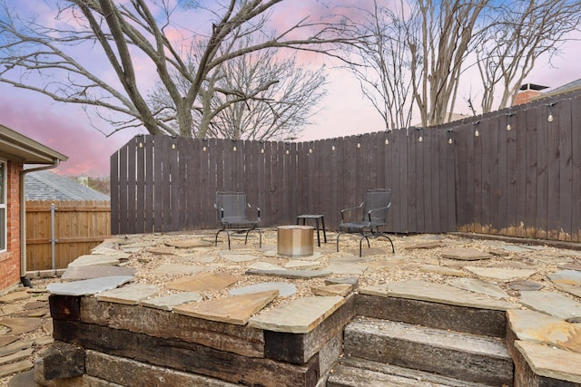 view of patio terrace at dusk