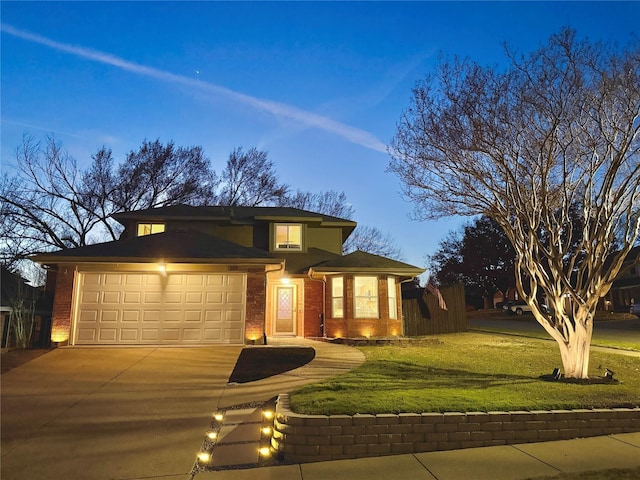 view of front of home featuring a garage and a lawn