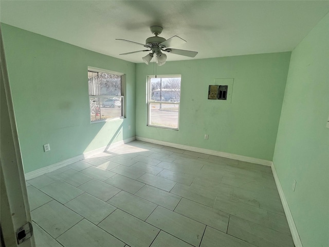 empty room featuring ceiling fan and light tile patterned floors