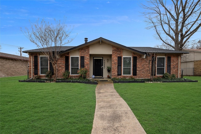 view of front of property featuring a front lawn and brick siding