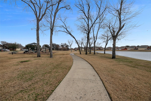 view of community featuring a yard and a water view