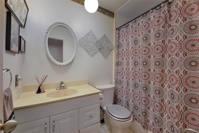 bathroom featuring toilet and vanity