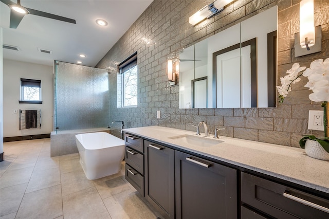 bathroom with vanity, tile patterned flooring, heating unit, separate shower and tub, and decorative backsplash