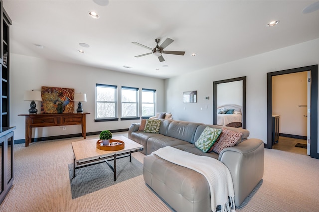 carpeted living room with ceiling fan